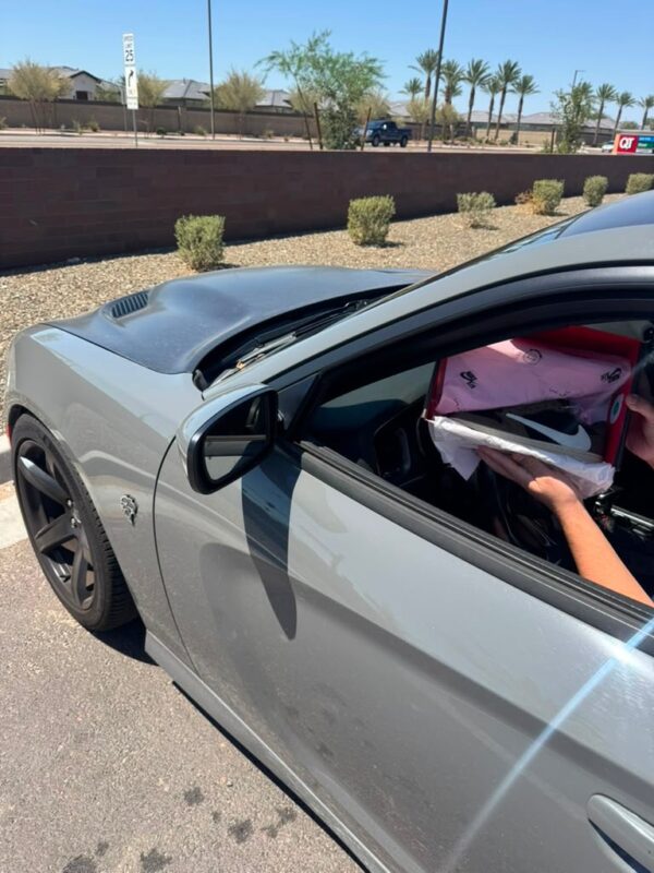Customer receiving Travis Scott style Air Jordan 1 Low in car on delivery day